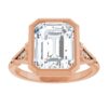rose gold moissanite ring with bezel and diamond accents